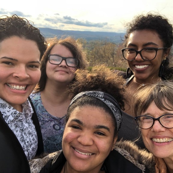 Five people smiling together